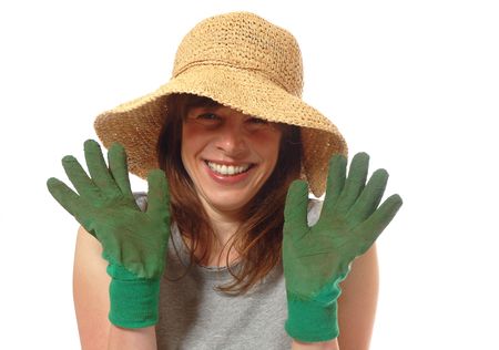 cute smiling young lady gardener with trowel & rake, isolated on whiteの写真素材