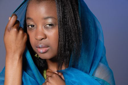 portrait of attractive young African girl in teal wrapの写真素材