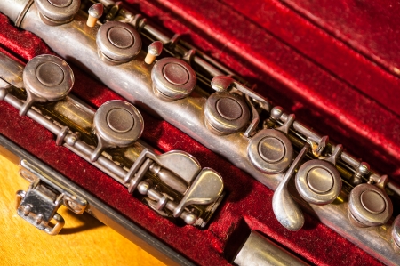 Tarnished old brass flute in velvet case, close-up of keysの写真素材