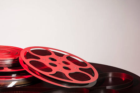 stacked canisters of movie film with film reel - film festival conceptの写真素材