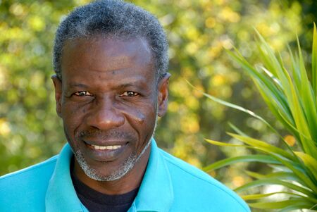 Happy mature man looking relaxed in garden