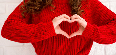 Unrecognizable female showing heart with her hands.Valentines or womenn's day conceptの写真素材