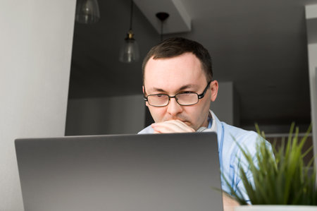 Closeup portrait of asian man thinking on problem solving looking at laptop screen, Descision...