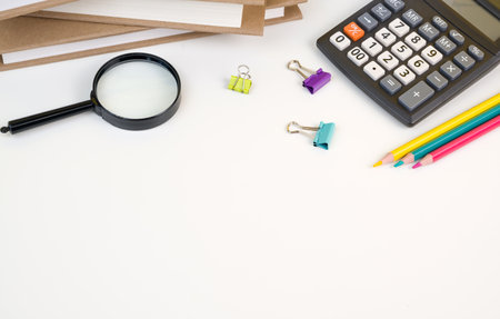 Back to school flatlay with books,calculator,pencils and other supplies on white bacground. Banner...