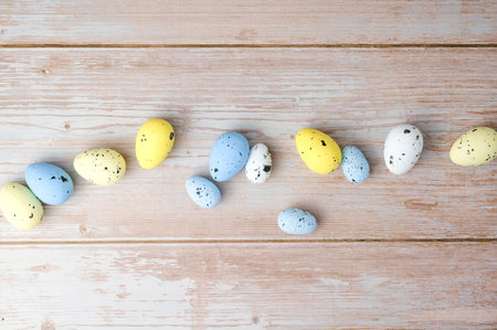 Top view on white,yellow and blue eggs. Easter flat layの写真素材