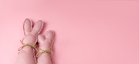Monochrome pink easter banner with toy bunnies. Place for textの写真素材