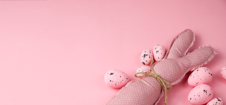 Monochrome pink easter banner with toy bunnies. Place for textの写真素材