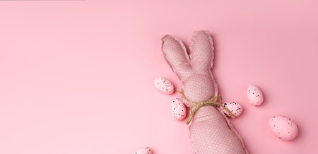 Monochrome pink easter banner with toy bunnies. Place for textの写真素材