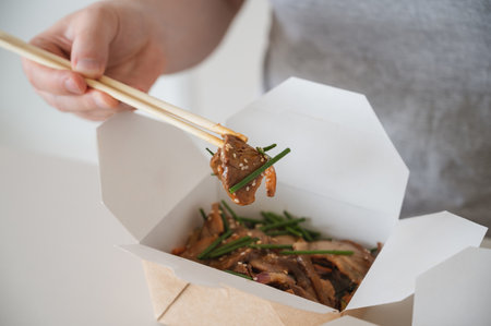Unregonizable man eating hot poke bowl with duck. Asian cuisineの写真素材
