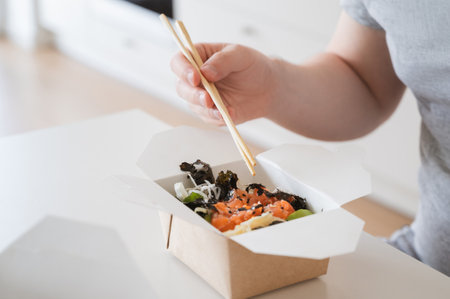 Salmon, avocado, seaweed poke bowl. Food delivery concept