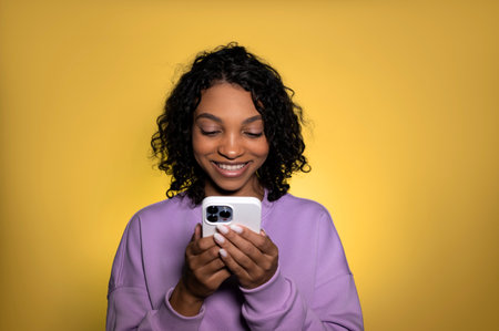 Happy smiling girl looking at phone scrre. Modern technologies, application use etc.の写真素材
