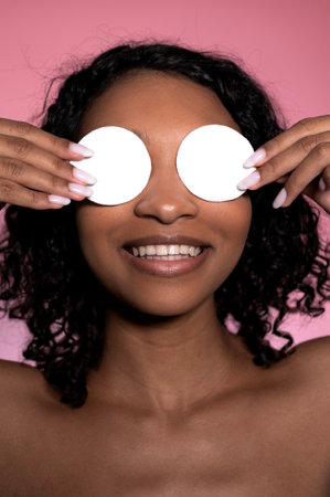 Beautiful Black Girl Removing Makeup White Cosmetic Cotton Pad.の写真素材