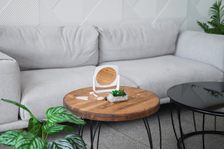 Beauty routine and skin care concept. Gua sha and jade roller on wooden table near mirror. Copy space banner with place for textの写真素材