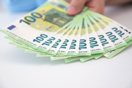 Closeup of hundred Euro banknotes on the table. Loan,salary,savings,cost of living,busines concept.Selective focus. High quality photoの写真素材