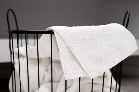 Household concept. A laundry basket full of dirty towels and clothesの写真素材