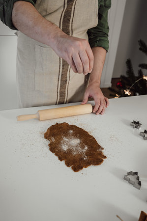 Man cooking homemade cookies for Christmas at home.