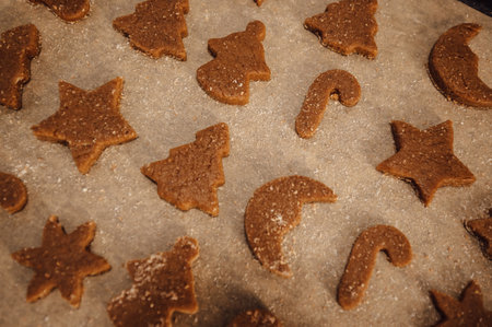 top view Gingerbread cookies on baking tray in christmas shapes of tree,candy cane,stars etcの写真素材