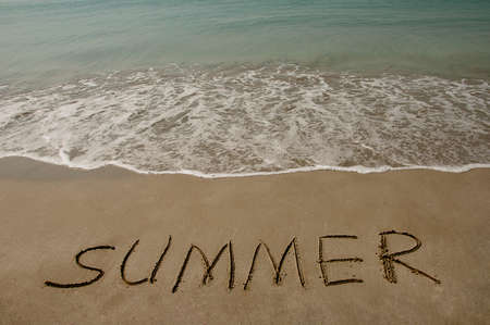 Text summer written on a brown beach with sea floor and blue sky.
の写真素材