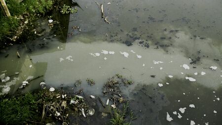 Water pollution caused by the discharge of sewage into the river from the apartments or home.の写真素材