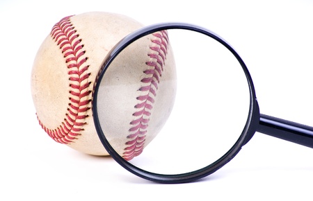 baseball ball with magnifying glass on white backgroundの写真素材