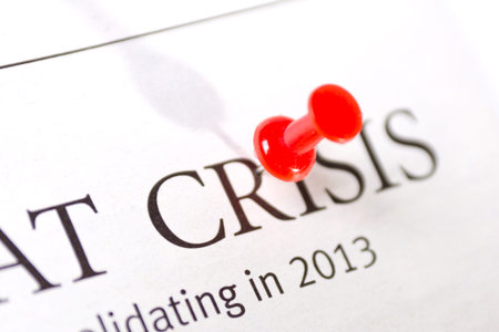 word a crisis is written in a newspaperの写真素材