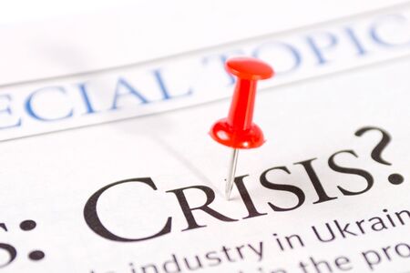 word a crisis is written in a newspaperの写真素材