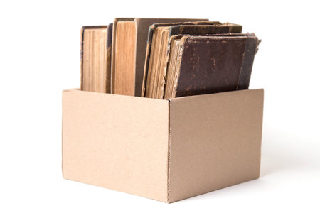 few age-old books, standings alongside, on a white backgroundの写真素材