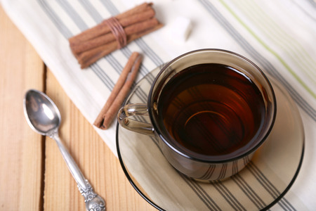 cup of tea with sugar and cinnamon on a wooden backgroundの写真素材