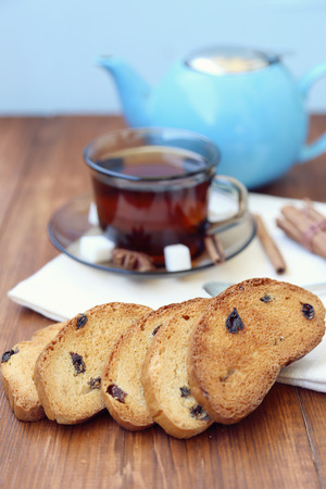 fresh tea in transparent cup,with rusks on wooden backgroundの写真素材