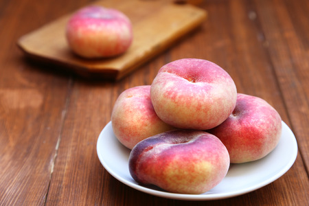 some fresh ripe  peaches on wooden backgroundの写真素材
