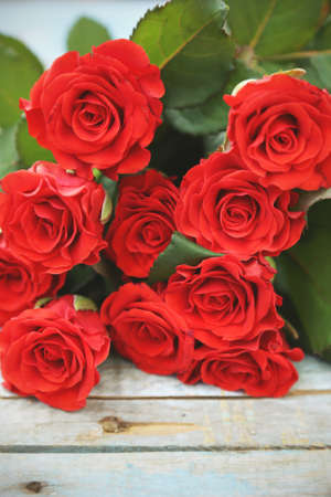 beautyful fresh red roses on wooden backgroundの写真素材