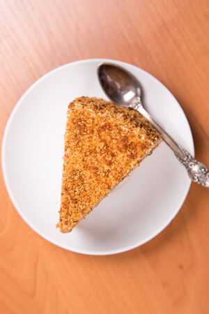 piece of fresh cake on a white dish in a studioの写真素材