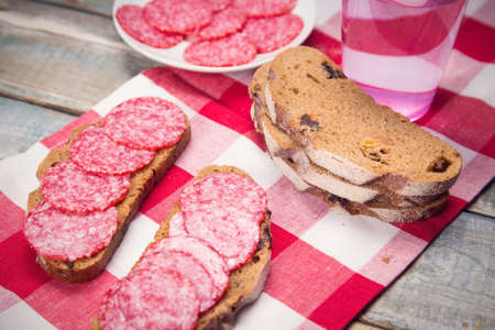 fresh bread with sausage on wooden table in studioの写真素材