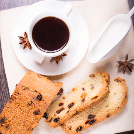 fresh coffee with anis,cake and milk on wooden backgroundの写真素材