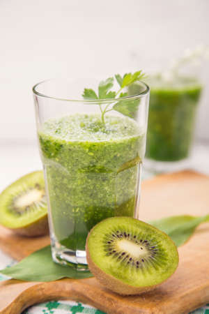 fresh green fruit smoothie in transparent glassの写真素材