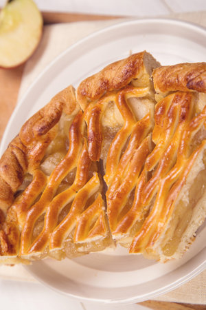 pieces of fresh apple-pie with filling on a wooden backgroundの写真素材