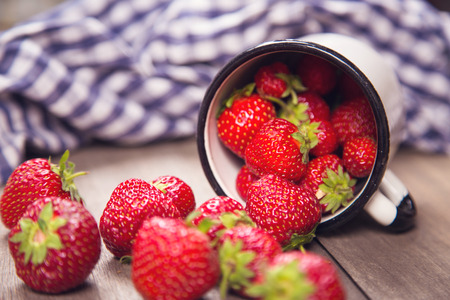 fresh ripe bright strawberry is in a white cup, in a studioの写真素材
