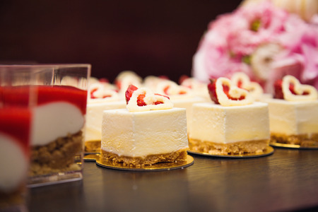 some fresh cakes with strawberry in a restaurantの写真素材