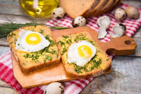 fried eggs on wooden plate with bread,oil in studioの写真素材