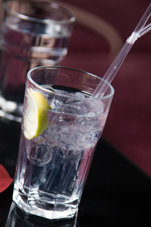 an alcoholic transparent cocktail is in beautiful glass, on the barの写真素材