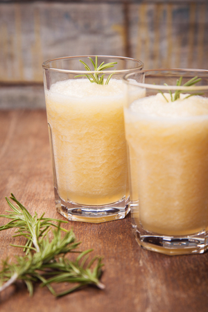 fresh juicy melom smoothie with rosemary in studioの写真素材