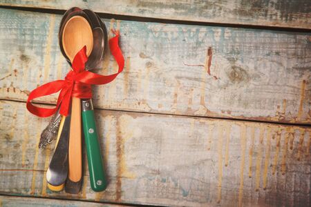 metallic and wooden retro spoons,in red ribbonの写真素材