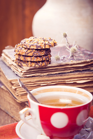 cup of fresh tea, with a Ñookies, near old booksの写真素材