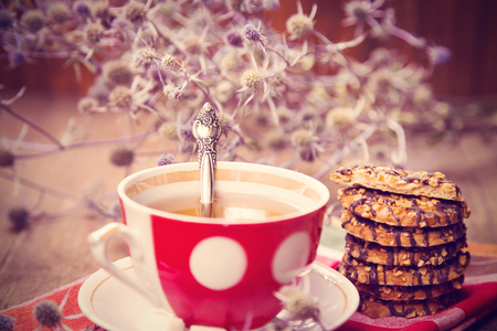 cup of fresh tea, with a Ñookies, on red textileの写真素材