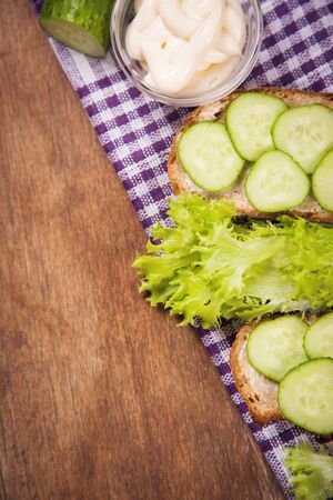 slice of bread with mayonnaise and fresh cucumberの写真素材