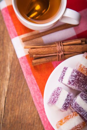 many marmalade candys with fresh tea in studioの写真素材