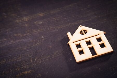 small wooden symbol of house in studio on black backgroundの写真素材