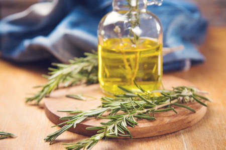 fresh green rosemary and bottle with olive oil in studioの写真素材