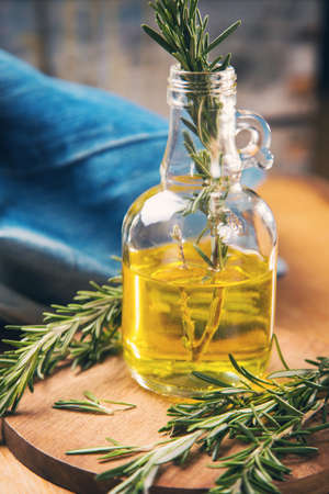 fresh green rosemary and bottle with olive oil in studioの写真素材