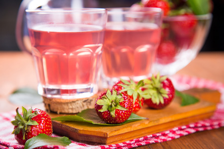 fresh hot strawberrys compote with ripe red strawberry on wooden backgroundの写真素材
